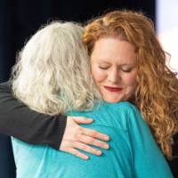 Two people hugging and smiling